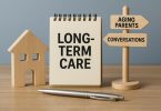 Hands holding a notepad and pen over documents about long-term care planning for aging parents